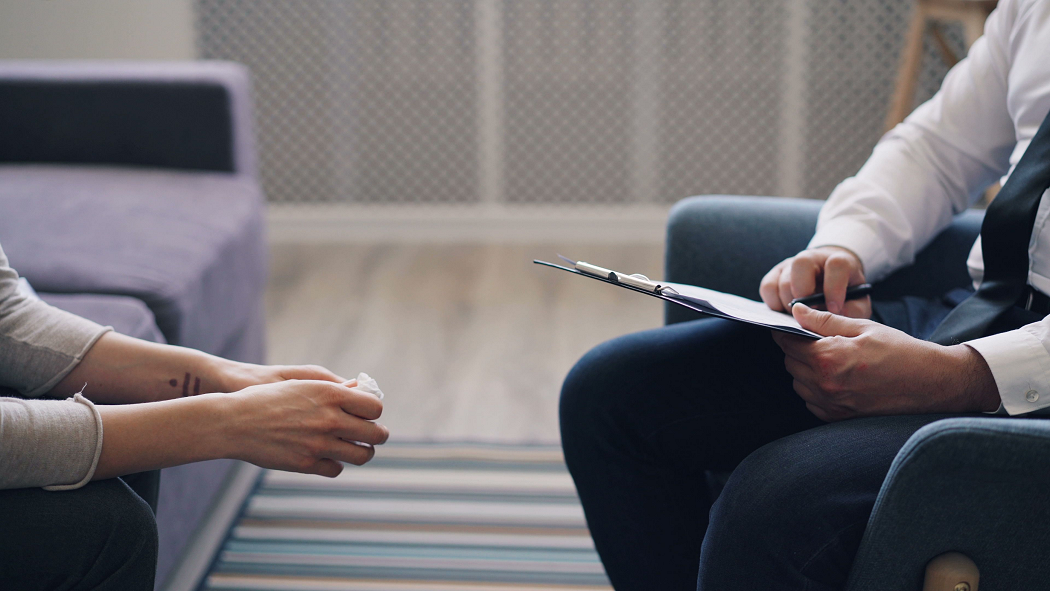 Therapist listening to a patient